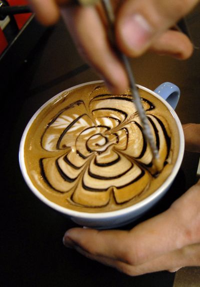 Barista Marcus Davis designs a flower shape on a mocha for a customer at Black Tie Coffee Co. in Post Falls in 2008. (FILE)
