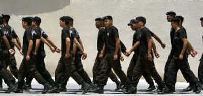 
Members of Palestinian President Mahmoud Abbas' security force march inside his headquarters Tuesday in Ramallah, West Bank. Associated Press
 (Associated Press / The Spokesman-Review)