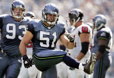 
Seattle's Lofa Tatupu (51) reacts after sacking Falcons quarterback Michael Vick in the second quarter of Seattle's 21-18 victory over Atlanta. 
 (Associated Press / The Spokesman-Review)