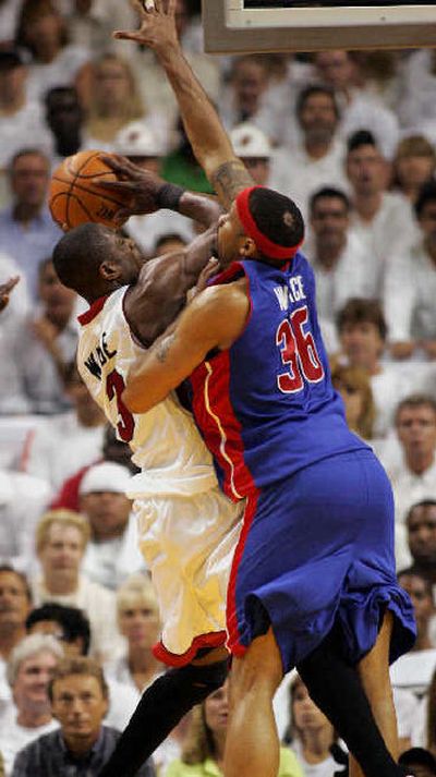 
Detroit's Rasheed Wallace blocks a shot by Miami's Dwayne Wade on Saturday.
 (Associated Press / The Spokesman-Review)