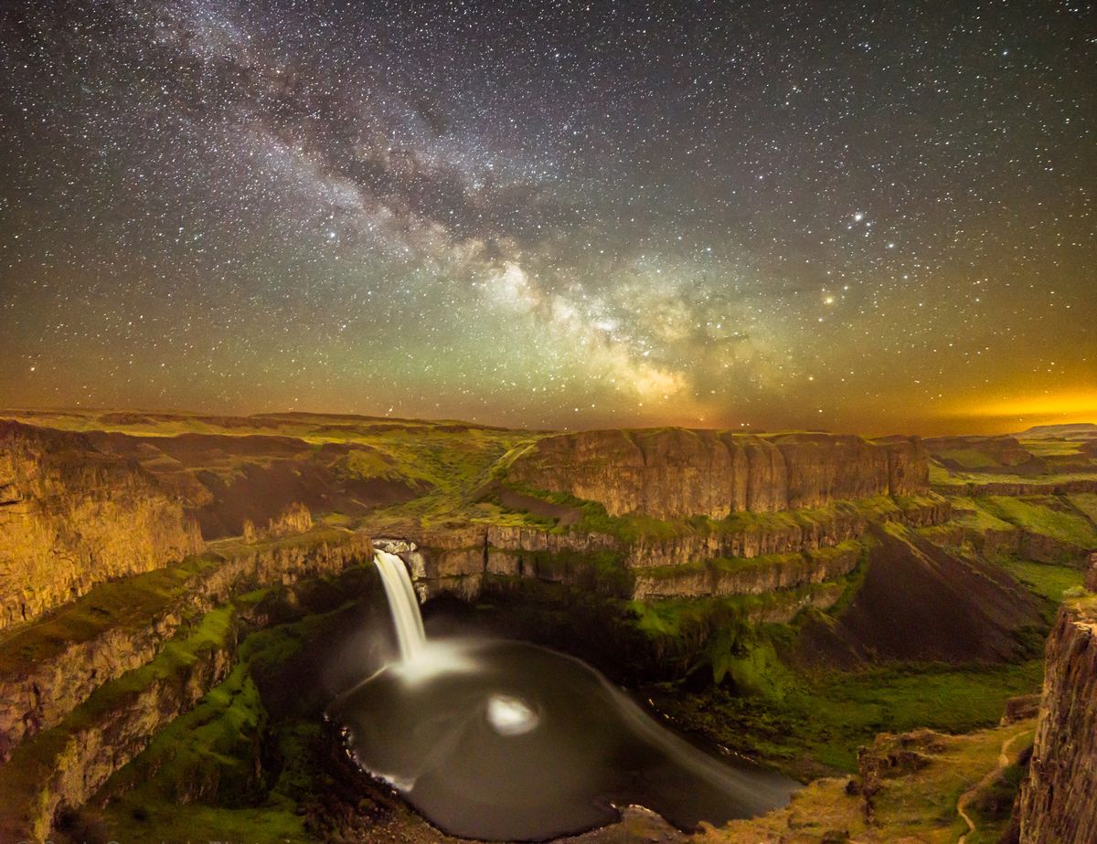 Palouse Falls in an almost mystical aura, with the lights of Walla Walla visible on the horizon to the right. (Craig Goodwin)
