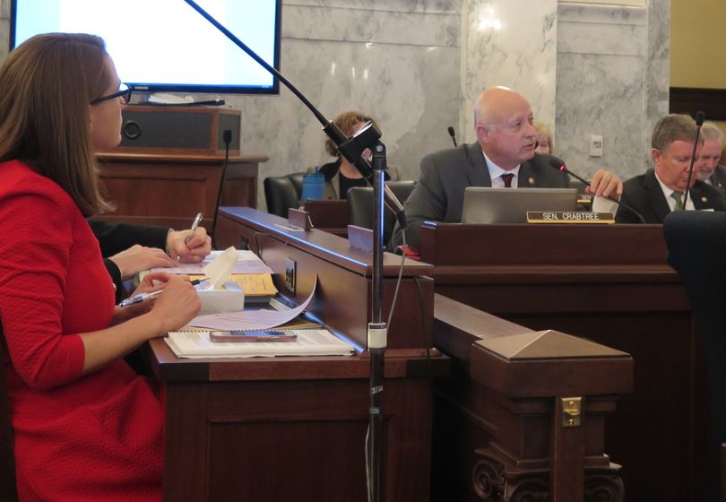 Sen. Carl Crabtree, R-Grangeville, makes the motion in the Idaho Legislature's joint budget committee to restore $27.6 million for road projects that wasn't transferred last year, despite lawmakers having approved it, due to a drafting error in the bill. At left is Jani Revier, Gov. Butch Otter's budget chief. (Betsy Z. Russell)