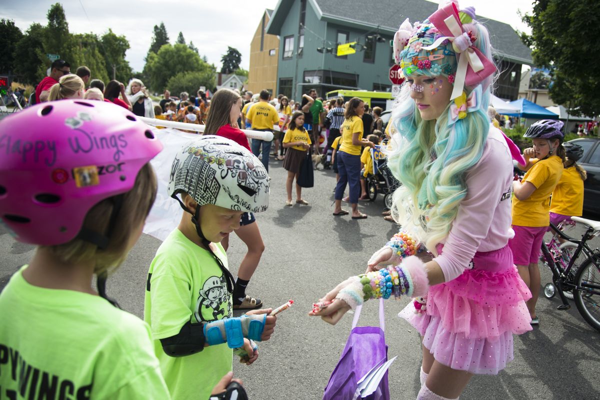 Dressed as a Japanese anime character, Orionna Lightning hands out candy to children along the Perry Street Parade route Saturday during the South Perry Street Fair and Parade. The event also featured live music, kids’ events, crafts and food vendors. (Colin Mulvany)