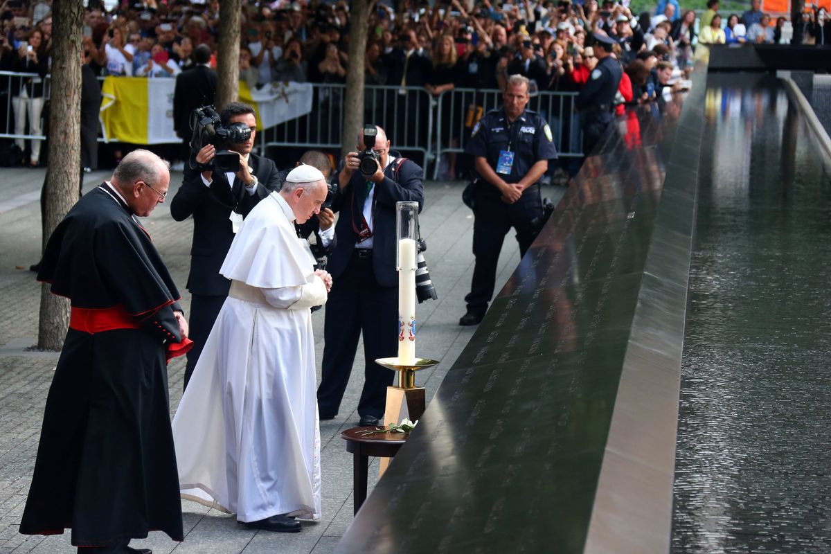 Pope Francis, in white, is accompanied by Cardinal Timothy Dolan, left, during his visit to the National September 11 Memorial & Museum in New York on Sept. 25, 2015. Pope Francis, who rose from modest means in Argentina to become the first Jesuit and Latin American pontiff, died at the Vatican on Monday, April 21, 2025. He was 88. (Chang W. Lee/The New York Times)