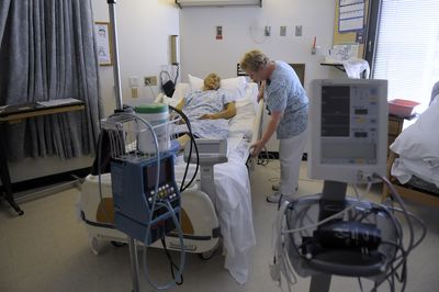 Linda Span, a registered nurse at Deaconess Medical Center, works with patient John Porter last week.   (CHRISTOPHER ANDERSON / The Spokesman-Review)