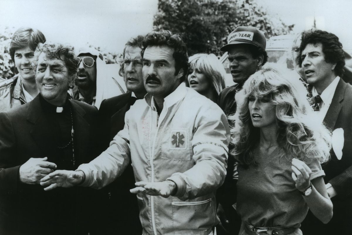 From left, Dean Martin, Roger Moore, Burt Reynolds and Farrah Fawcett will stop at nothing to compete in a wacky cross-country race in the action-packed comedy “The Cannonball Run,” on HBO. A souped up E63 AMG was driven cross-country in 27 hours and 25 minutes, a record for the Cannonball Run auto race from New York to Redondo Beach, California. (HBO/Cinemax)