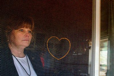 
Debra Baptist, executive director of Bonner County Homeless Task Force, looks out the back screen door of Harmony House women's shelter in Sandpoint on Thursday. 
 (Kathy Plonka / The Spokesman-Review)