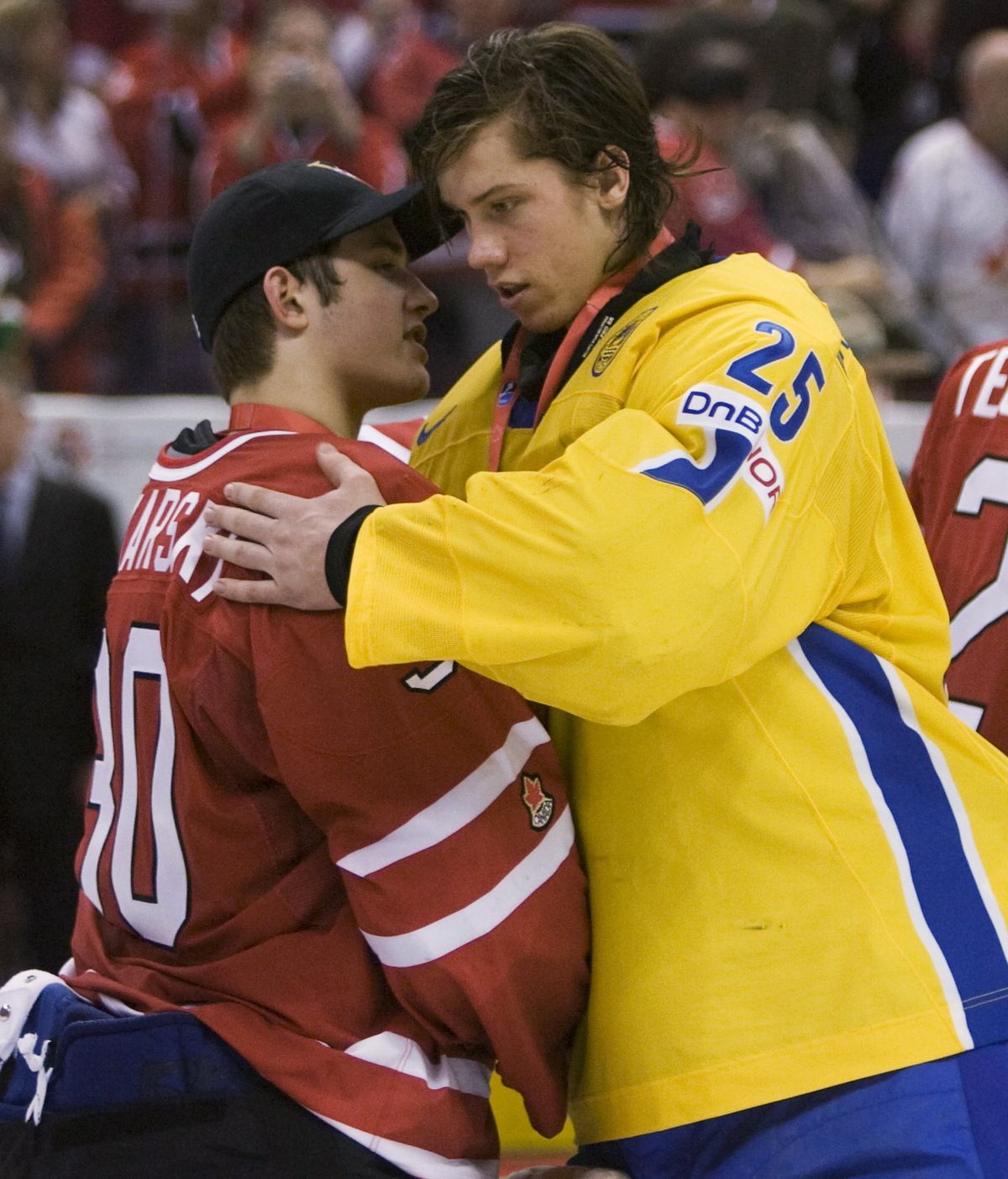 Dustin Tokarski, left, is congratulated by Team Sweden goalie Jacob Markstrom following Canada’s 5-1 win Monday.  (Associated Press / The Spokesman-Review)