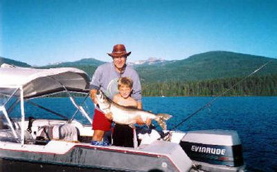 Quinn Kopczynski, 7, of Spokane needed help from his father, Chris Kopczynski, last summer (2005)to lift this huge 38 1/2 inch long mackinaw. Quinn caught the mack at Priest Lake while trolling using a spining rod and six-pound test line. (Photo courtesy of Chris Kopczynski / The Spokesman-Review)