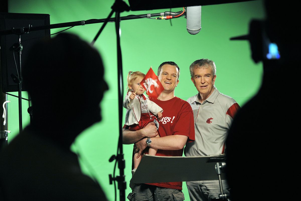 Brian Gates, center, along with his daughter, Adleigh, and his father, John Gates, participate in Washington State University’s casting call for the marketing campaign “Wave the Flag,” on Saturday at the Masonic Temple in Spokane. Both men are Cougar alumni. Fans were invited to state before cameras why they wave the WSU flag. (PHOTOS BY DAN PELLE)