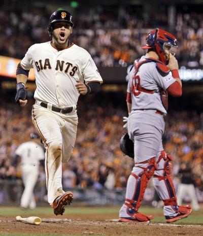 Gregor Blanco scores on an RBI single by Buster Posey in Giants’ three-run sixth. (Associated Press)