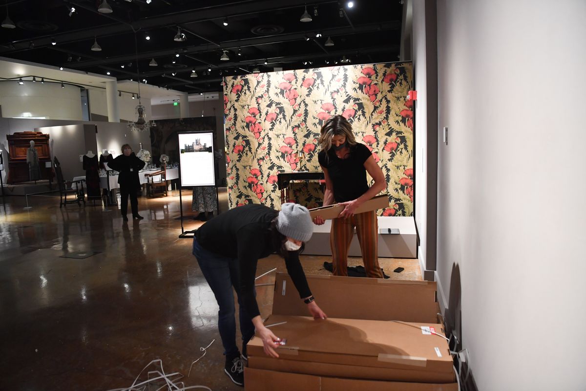 Renee Webber, left, and Tammy Gabbert with the MAC work to prepare “Dressing the Abbey: The Iconic Wardrobe of ‘Downton Abbey’ ” on Friday at the MAC in Spokane.  (Tyler Tjomsland/THE SPOKESMAN-REVIEW)