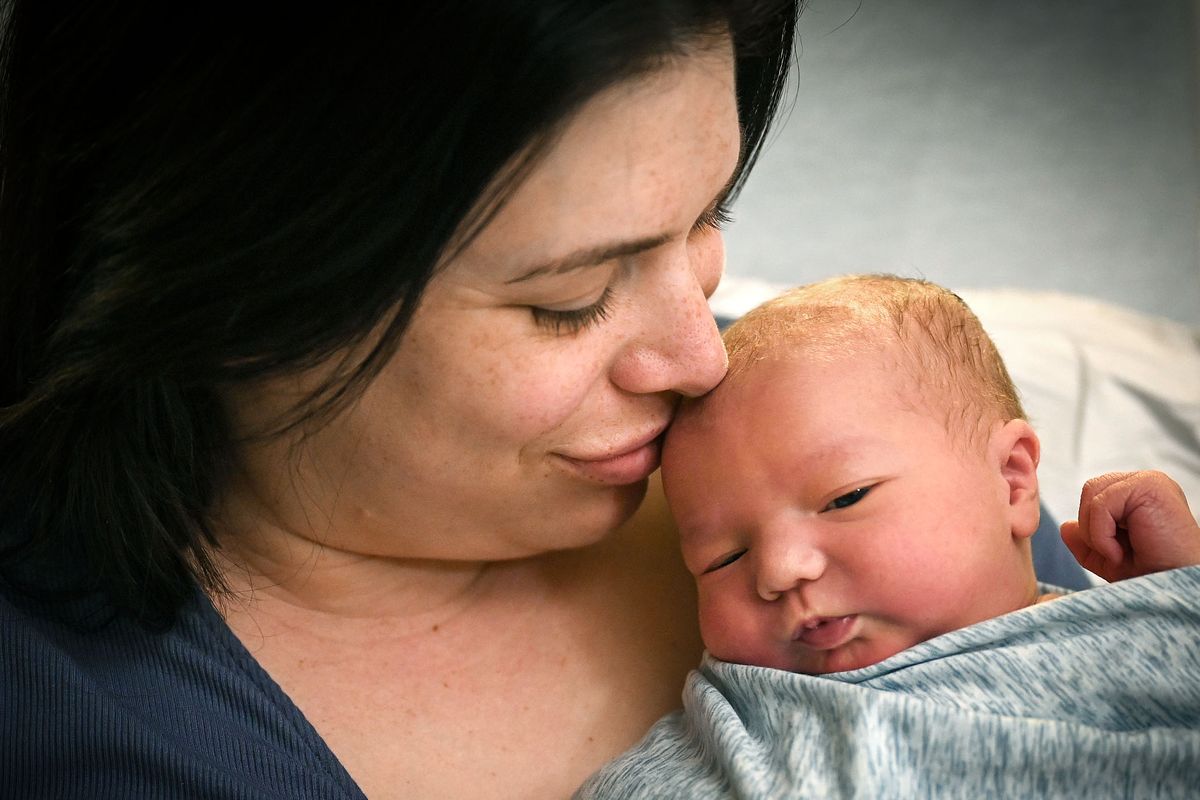 Marketa Williams gave birth to baby Ben in the early hours of leap day on Thursday morning. Here, she cuddles with Ben at MultiCare Deaconess Hospital Friday morning.  (DAN PELLE/THE SPOKESMAN-REVIEW)