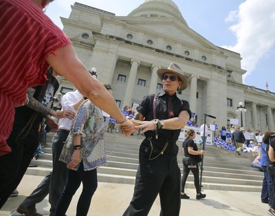 Actor Johnny Depp greets someone as he walks to the podium to speak at a rally opposing Arkansas’ upcoming executions, which were set to begin Monday, on the front steps of the Capitol Friday in Little Rock, Ark. (Stephen B. Thornton / Associated Press)