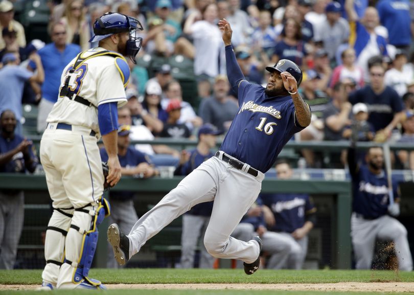 Milwaukee’s Domingo Santana scores a run against the Mariners in 2016. Santana was traded Friday from the Brewers to Seattle for Ben Gamel. (Elaine Thompson / Associated Press)