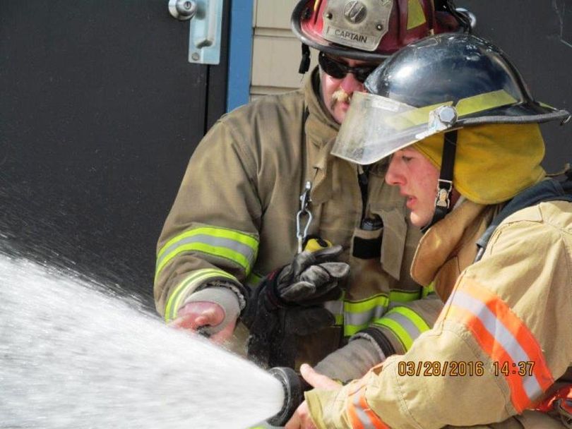Coeur d’Alene Charter Academy senior Michael Graves, pictured here with Capt. Bill Deruyter of the Coeur d’Alene Fire Department, is one of three students participating in the fire department’s new Cadet Program this semester. (Courtesy: Coeur d'Alene Fire Department)