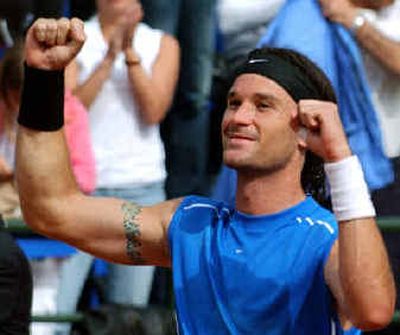 
 Carlos Moya reacts after defeating Argentina's David Nalbandian during the final of the men's clay court Italian Open tennis tournament on Sunday in Rome.   Carlos Moya reacts after defeating Argentina's David Nalbandian during the final of the men's clay court Italian Open tennis tournament on Sunday in Rome.  
 (Associated PressAssociated Press / The Spokesman-Review)