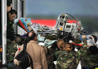 
CBS News correspondent Kimberly Dozier is lifted Tuesday into an ambulance at the U.S. Air Base in Ramstein, Germany. Dozier was hurt Monday in a U.S. military convoy  when a car bomb exploded. 
 (Associated Press / The Spokesman-Review)