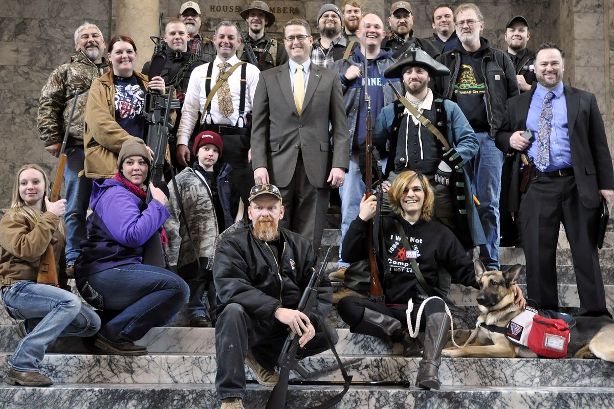 Rep. Matt Shea poses with gun rights advocates on the steps outside the House chambers after the rally Thursday outside the Capitol. (Jim Camden)