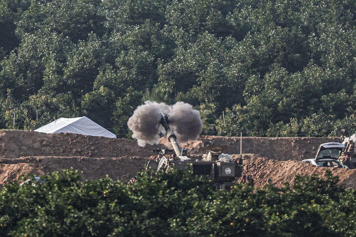 A picture taken from southern Israel near the border with the Gaza Strip on Monday shows an Israeli tank firing toward Palestinian territory amid continuing battles between Israel and the militant group Hamas.  (Getty Images )