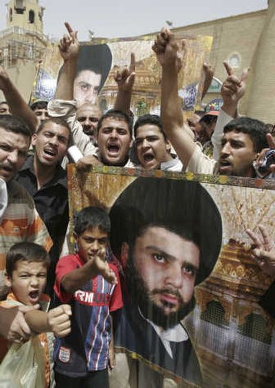 
Iraqis hold posters of anti-U.S. cleric Muqtada al-Sadr after prayers in the city of Kufa,  south of Baghdad,  Friday. Associated Press
 (Associated Press / The Spokesman-Review)