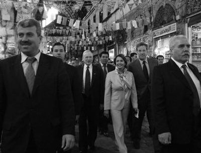
Two Syrian security men escort U.S. House Speaker Nancy Pelosi  at a popular market in downtown Damascus, Syria, on Tuesday. 
 (Associated Press / The Spokesman-Review)
