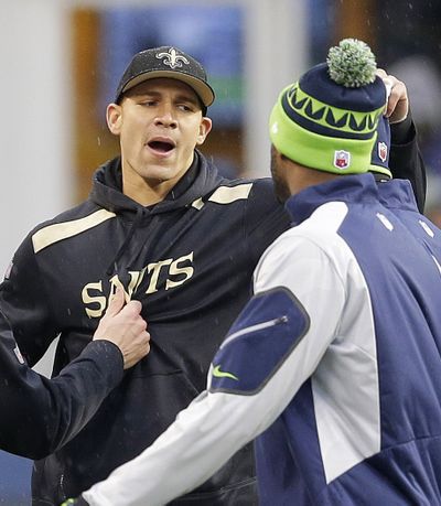 New Orleans Saints tight end Jimmy Graham, second from left, is pulled away from Seattle Seahawks players before their  NFC divisional playoff game in Seattle.
 (Ted Warren / Associated Press)