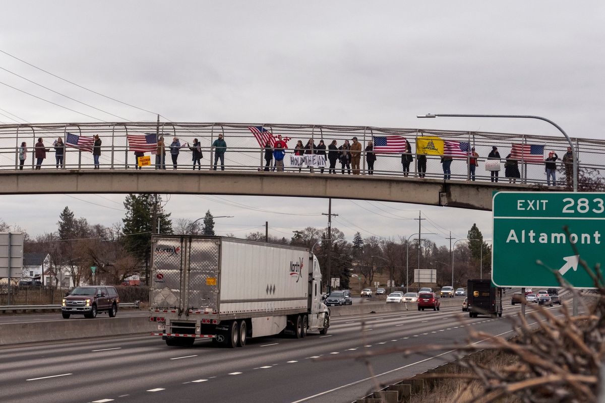 Supporters of a convoy of truckers gather Wednesday on the pedestrian overpass near Third Avenue and Magnolia Street in East Central Spokane.  (Jesse Tinsley/The Spokesman-Review)