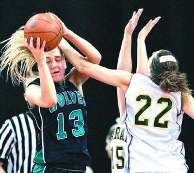 
Borah's Rebecca Stafford whacks Lake City senior Brittany Bemis during the teams' State 5A opener Thursday in Nampa. 
 (Matt Cilley Special to / The Spokesman-Review)