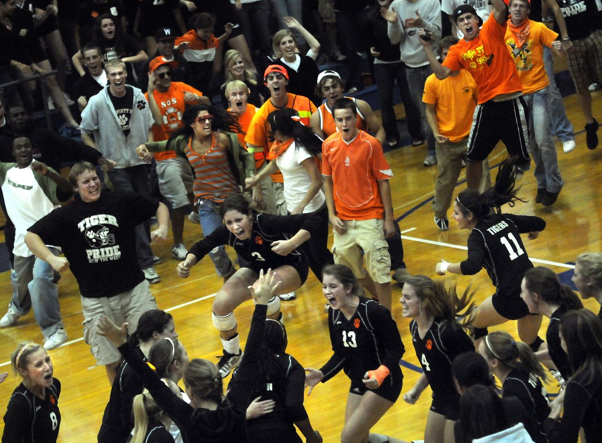 Lewis and Clark players and fans celebrate the Tigers’ victory over five-time defending State 4A champion Mead.  (Rajah Bose / The Spokesman-Review)