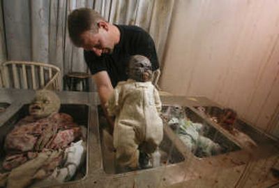 
13th Gate Haunted House technical director Scott Meyer reconnects a doll to a spring mechanism at the Baton Rouge, La., facility. Associated Press
 (Associated Press / The Spokesman-Review)