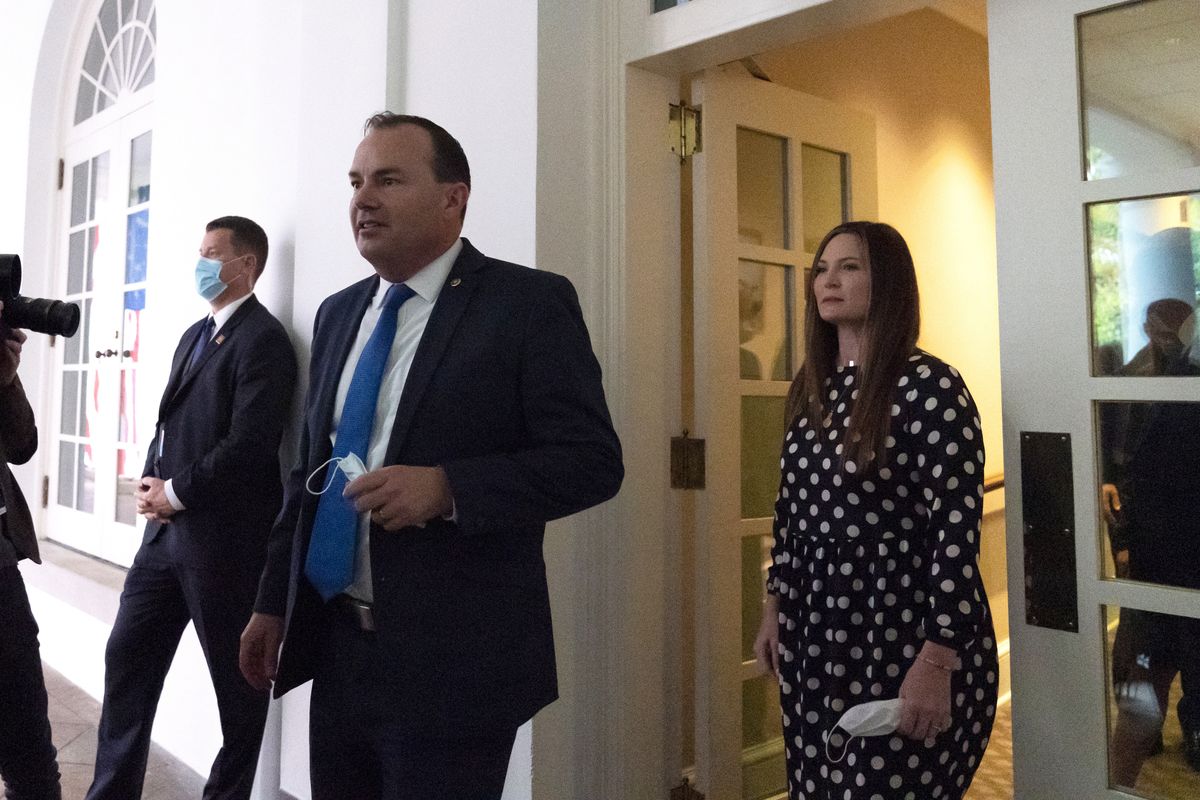 In this Saturday, Sept. 26, 2020, photo, Sen. Mike Lee, R-Utah, center, steps out of the West Wing to watch as President Donald Trump announces Judge Amy Coney Barrett as his nominee to the Supreme Court, in the Rose Garden at the White House in Washington.  (Alex Brandon)