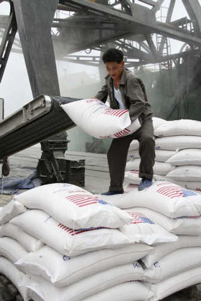 Sacks of Washington-grown wheat are unloaded Sunday from the MV Baltimore in the port of Nampo, North Korea. Associated Press
 (Associated Press / The Spokesman-Review)