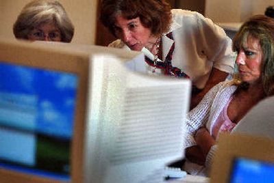 
Lori Kinnear, center, explains the functions of a personal computer to Jessica Skok, left, and Johrene Chappell at the downtown YWCA. 