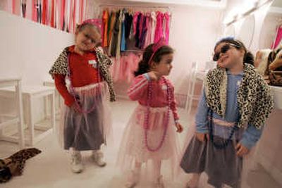 
Girls try on Barbie costumes at the Barbie Store in Buenos Aires. At the newly opened 6,996-square-foot store dedicated to the world's No. 1 fashion doll, girls can get glittery hairdos and makeup at the Barbie beauty parlor or try on gowns and play with dolls in the Barbie playroom, all while their parents nibble pink-frosted desserts in the Barbie cafe. Associated Press
 (Associated Press / The Spokesman-Review)