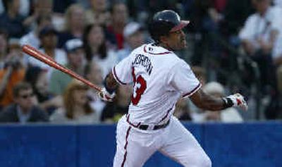 
Atlanta's Brian Jordan hits a grand slam off Mets pitcher Aaron Heilman on Saturday. 
 (Associated Press / The Spokesman-Review)