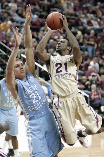 Florida State's Michael Snaer gets a shot off past the defense (Associated Press)
