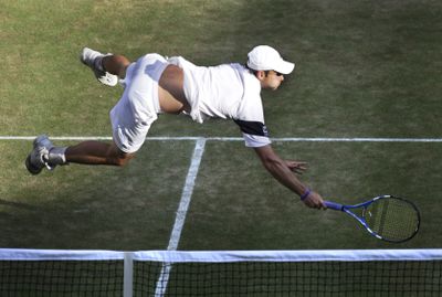 Andy Roddick of the United States sprawls for a return from Andy Murray during Friday’s men’s semifinal at Wimbledon.  (Associated Press / The Spokesman-Review)