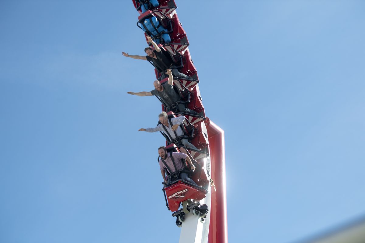 Riders, including Spokesman-Review reporter Kip Hill in the front seat, followed by coaster builder Fred Grubbs right behind him, scream as they navigate the biggest loop on the Stunt Pilot rollercoaster at Silverwood Theme Park Thursday, May 27, 2021 during a day of testing and media previews of the park’s newest rollercoaster, which opens officially Saturday. (Jesse Tinsley/The Spokesman-Review)