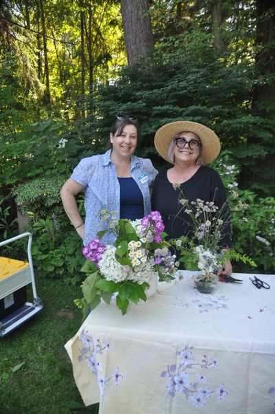 Lorene Edwards Forkner, right, and Grace Hensley show off bouquets of flowers they picked and arranged at Old Goat Farm in Graham, Washington, during a recent workshop for Northwest garden writers.  (Pat Munts/For The Spokesman-Review)