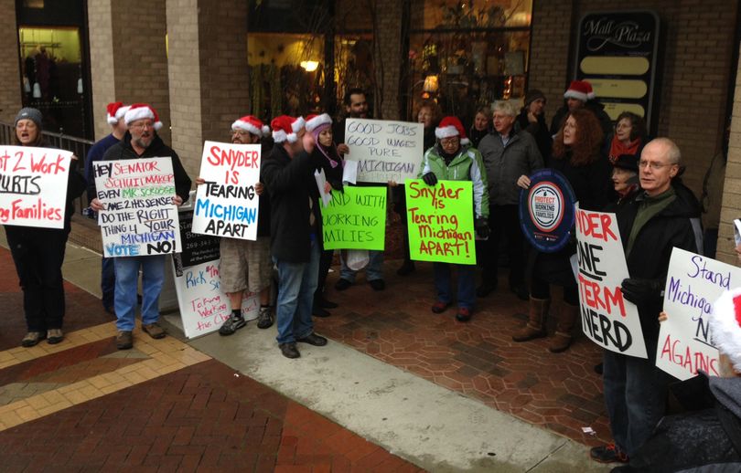 Union backers protest right-to-work bills outside Sen. Tonya Schuitmaker’s Kalamazoo, Mich., office Sunday. (Associated Press)