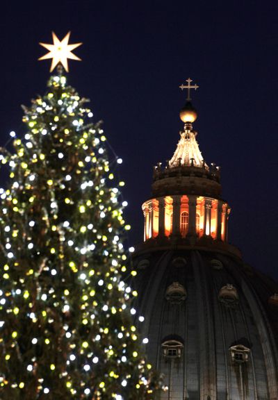 The St. Peter's Basilica is framed by the 30 meters (98 feet) Christmas tree that was lit for the first time at the Vatican, Friday Dec. 16, 2011. The tree was supplied by Ukraine. (Gregorio Borgia / Associated Press)
