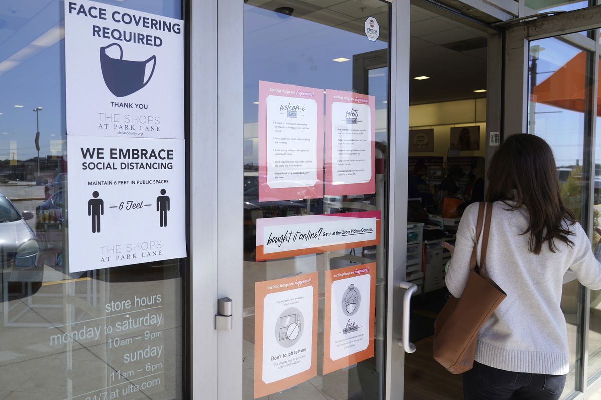 A customer enters a store with a face mask required sign displayed in Dallas, in this Tuesday, March 2, 2021 photo. Although nearly a fifth of U.S. states don't require people to wear masks to protect against COVID-19, some businesses are requiring employees and customers to be masked on their premises. (LM Otero)