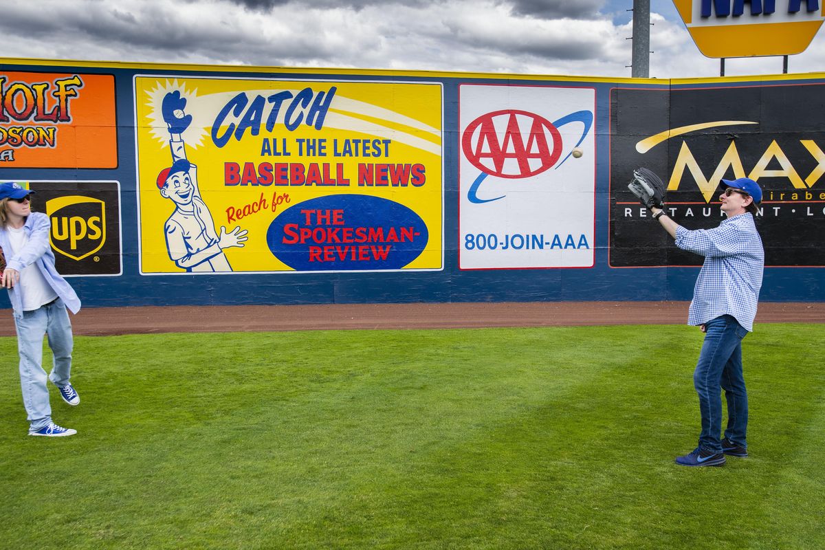 Johnathan Curley plays catch with his dad, Spokesman-Review Editor Rob Curley in center field at Avista Stadium before the Spokane Indians baseball game with the Boise Hawk, Sunday, June 17, 2018. (Colin Mulvany / The Spokesman-Review)