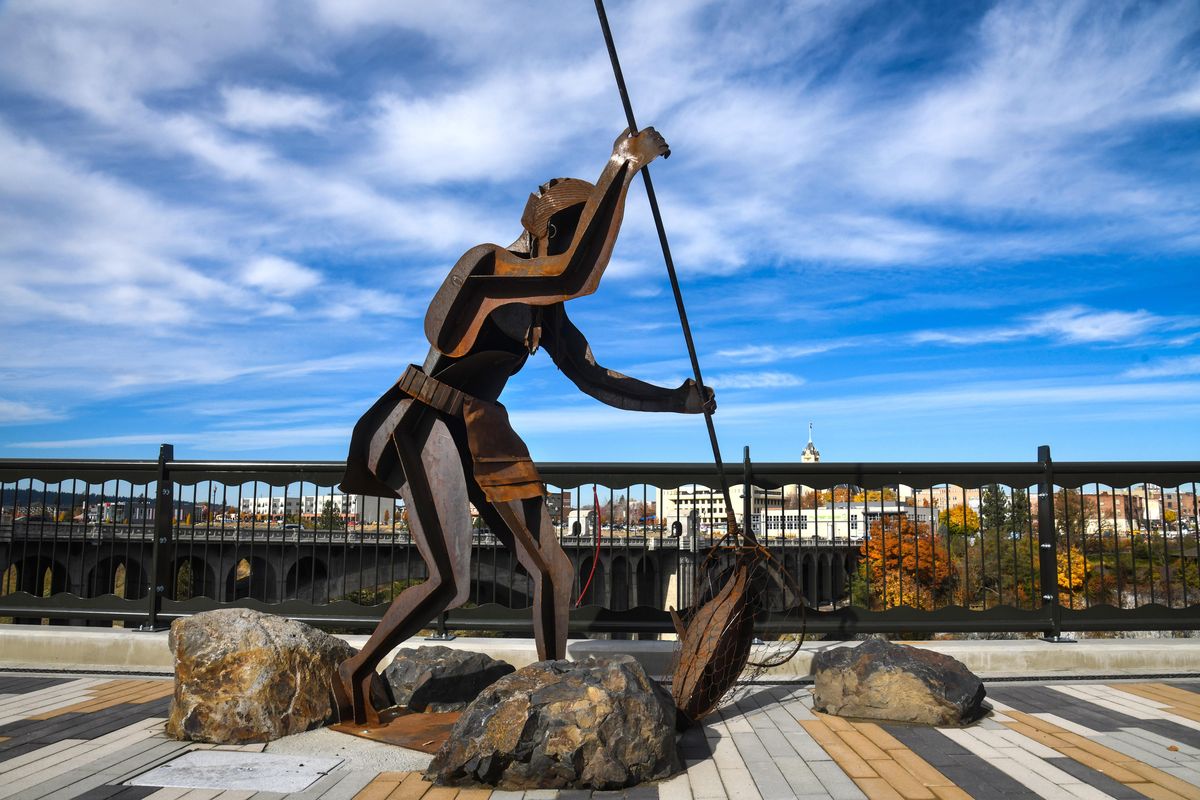 One of the fisher people by artists Jeff Ferguson and Smoker Marchand has been installed at the new pedestrian plaza on Spokane Falls Boulevard near City Hall, Friday, Oct. 25, 2019. (Dan Pelle / The Spokesman-Review)