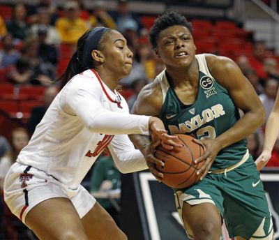 Texas Tech's Zuri Sanders tries to steal the ball from Baylor's Moon Ursin on Saturday in Lubbock, Texas. (Brad Tollefson / Associated Press)