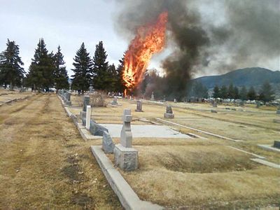 A fire burns inside the Holy Cross Cemetery on Sunday after a  plane crashed in an area just south of the Bert Mooney Airport in Butte. The Montana Standard (Martha Guidoni The Montana Standard / The Spokesman-Review)