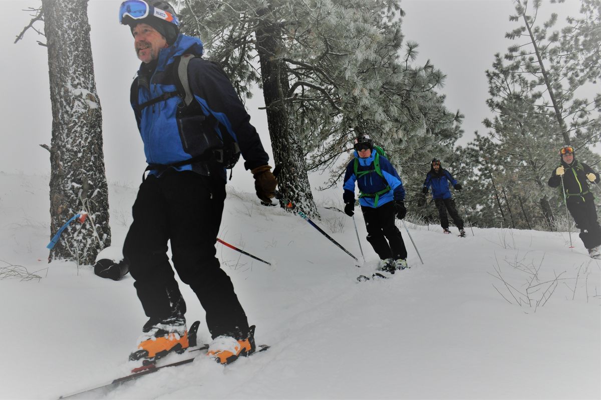 Mark Moore leads a group of downhill skiing buddies off of High Drive for a fall-line run down the South Hill Bluff on Jan. 9, 2017. (Rich Landers)