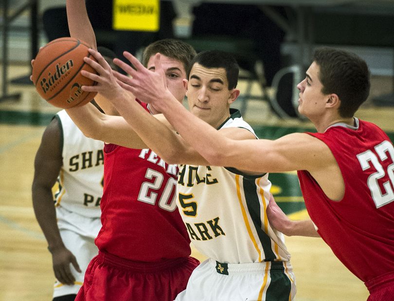 Shadle's George Pilimai is sandwiched between defenders Matt Belles (20) and Jared Christy of Ferris during the first half of a boy's high school basketball game, Friday, Jan. 31, 2014, at Shadle Park High School. (Colin Mulvany / The Spokesman-Review)