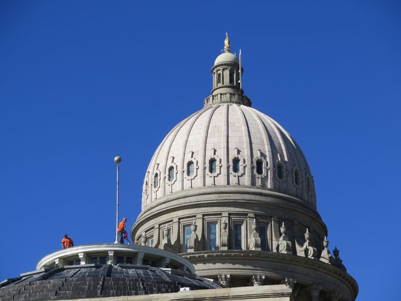 Two construction workers from Upsom Roofing, in orange shirts, work on the dome above the Idaho House chamber at the Idaho state Capitol, on Wednesday, Oct. 25, 2017. (Betsy Z. Russell)